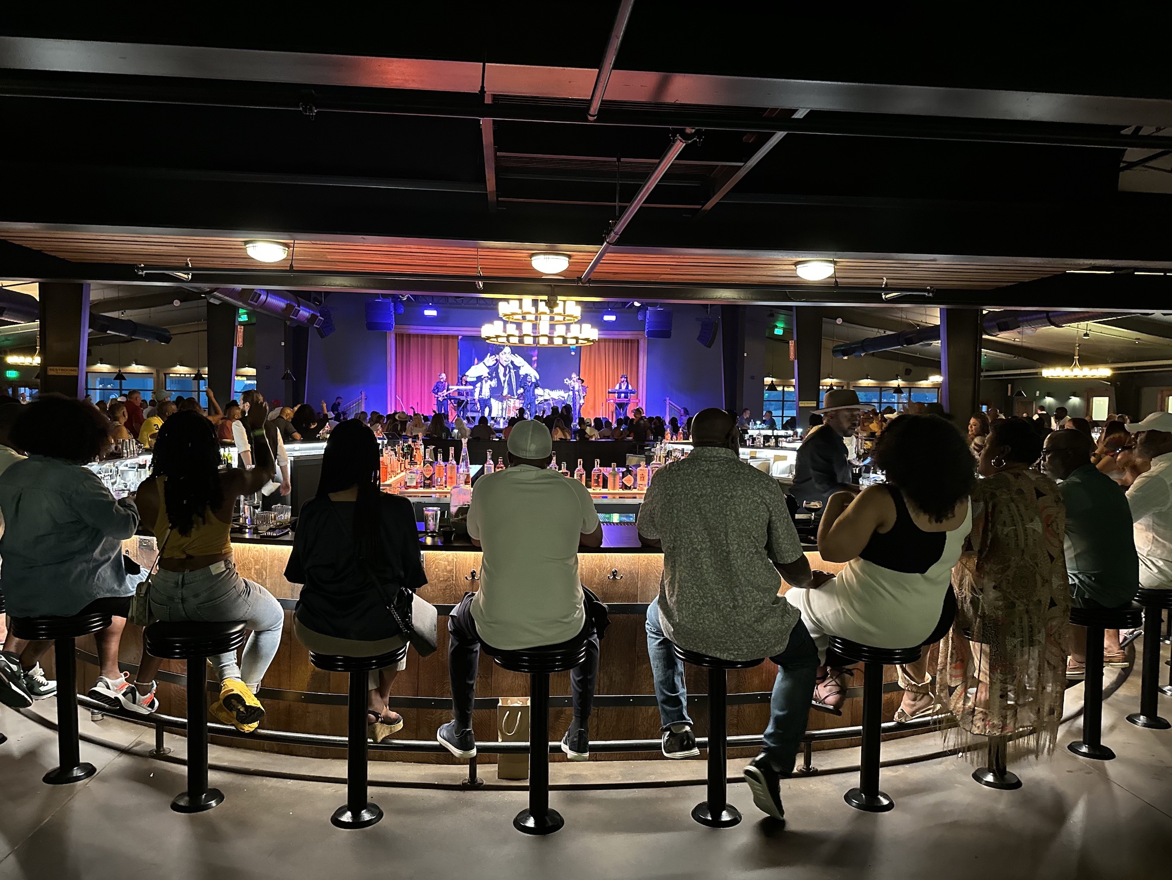 Guests seated around Humble Baron's stage and bar